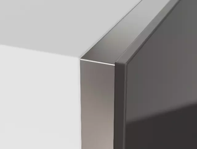 Brushed stainless steel side trim in a white cabinet.